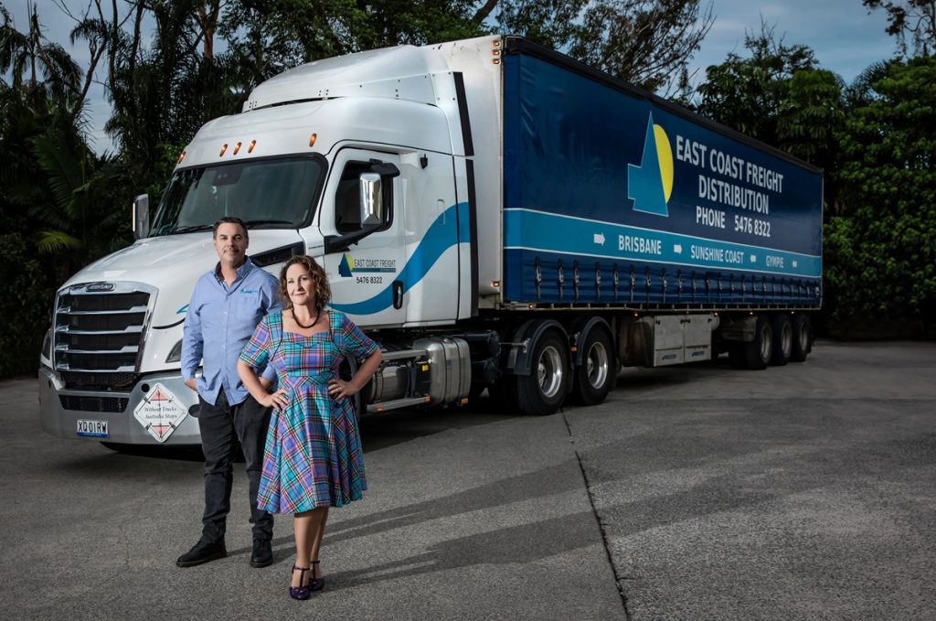 Shelly Barber, Executive Director, and Tim Mills, General Manager, of East Coast Freight Distribution in front of an articulated truck managing a variety of transport needs across Brisbane and the Sunshine Coast.